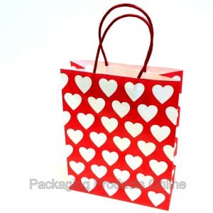 Red printed gift bag with white hearts all across it.