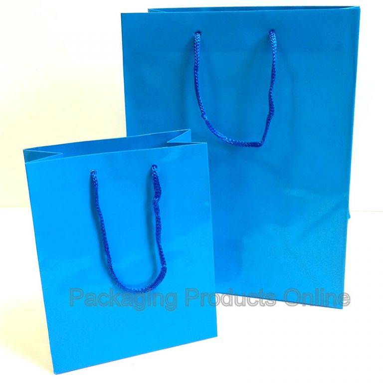 A small and medium sized glossy blue gift bag with blue cord handles.