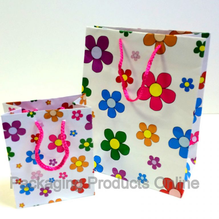 small and medium sized white gift bags printed with lots of daisy flowers in multiple colours